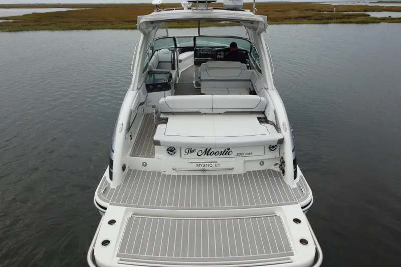 Slide: The Image of 2020 Formula 350 Crossover Bowrider on calm water, rear view, spacious deck. - 14