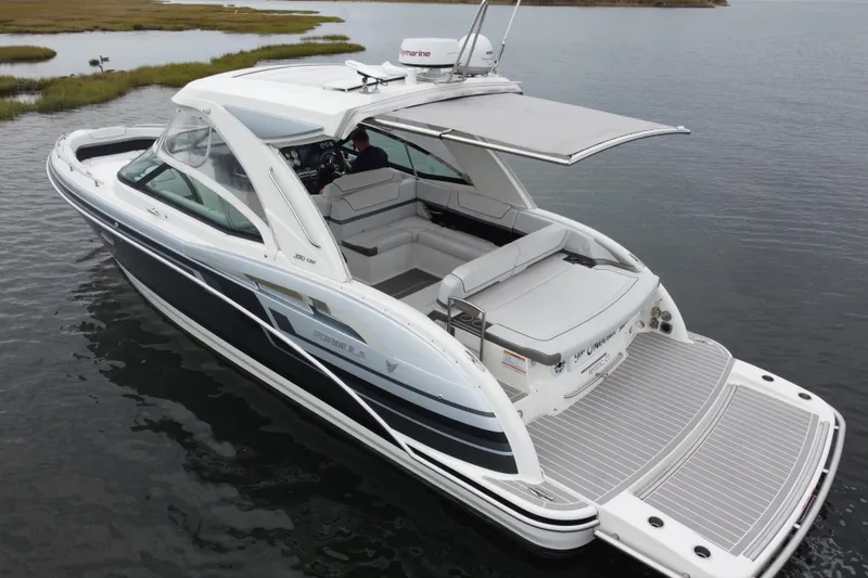 Slide: The Image of 2020 Formula 350 Crossover Bowrider on calm water, featuring spacious seating and sleek design. - 18