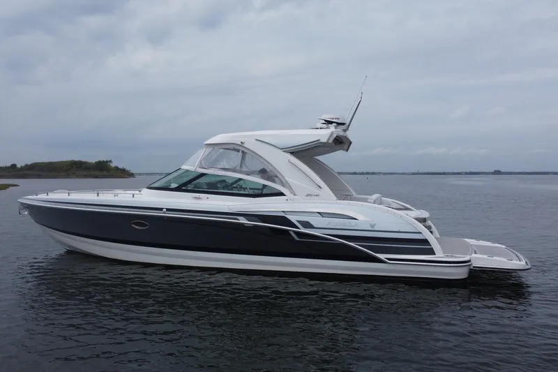 Slide: The Image of 2020 Formula 350 Crossover Bowrider on calm water, showcasing sleek design and luxury features. - 2