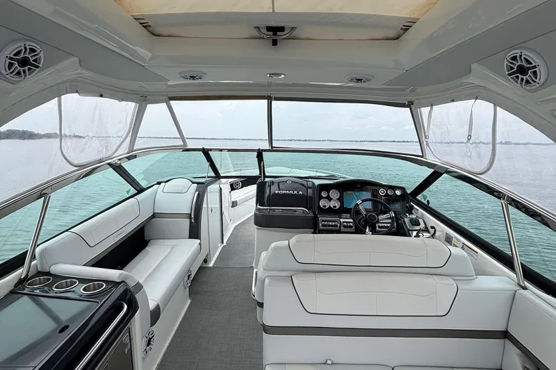 Slide: The Image of 2020 Formula 350 Crossover Bowrider interior with modern dashboard and seating on calm water. - 23
