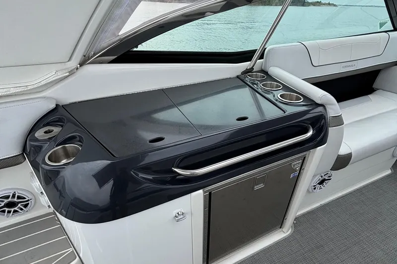 Slide: The Image of 2020 Formula 350 Crossover Bowrider interior with sleek kitchenette and cup holders. - 27