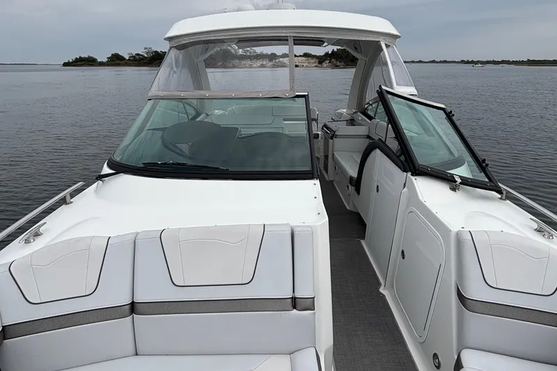 Slide: The Image of 2020 Formula 350 Crossover Bowrider on calm water, showcasing sleek design and spacious seating. - 31