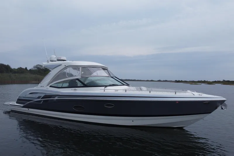 Slide: The Image of 2020 Formula 350 Crossover Bowrider on calm water, showcasing sleek design and luxury features. - 5