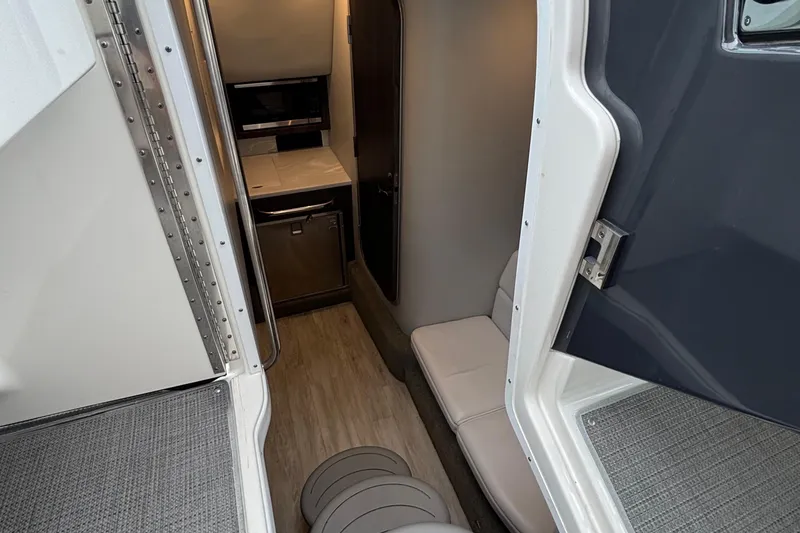 Slide: The Image of Interior view of 2020 Formula 350 Crossover Bowrider, featuring compact cabin amenities. - 56