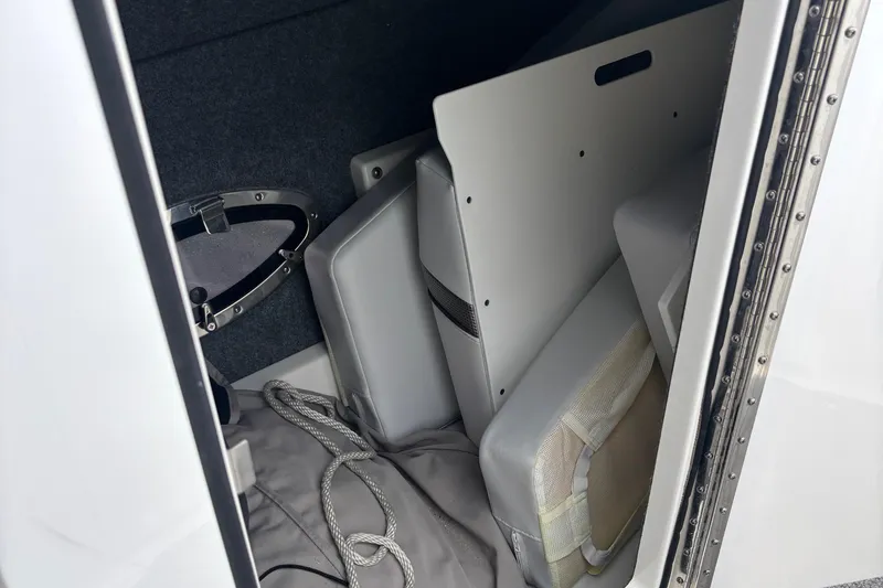 Slide: The Image of Storage compartment in a 2020 Formula 350 Crossover Bowrider boat with cushions and rope. - 58
