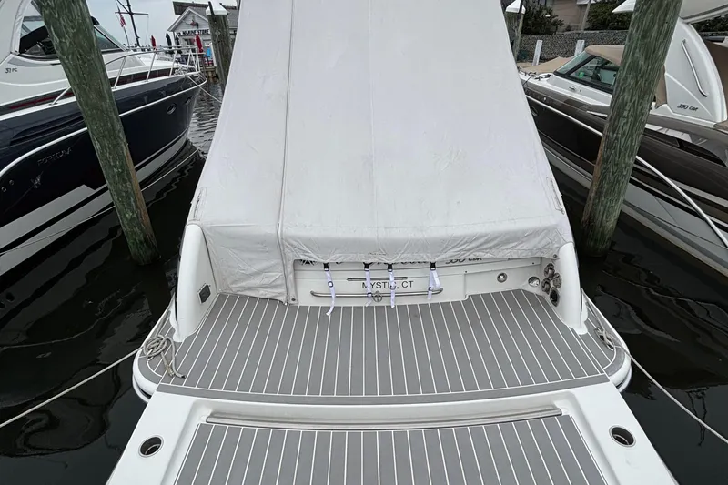 Slide: The Image of 2020 Formula 350 Crossover Bowrider docked, covered, with gray deck flooring. - 60