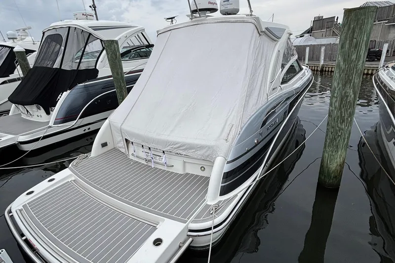 Slide: The Image of 2020 Formula 350 Crossover Bowrider docked with cover, showcasing sleek design. - 61