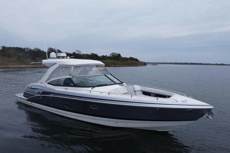 Slide: The Image of 2020 Formula 350 Crossover Bowrider on calm water, showcasing sleek design and luxury features. - 64