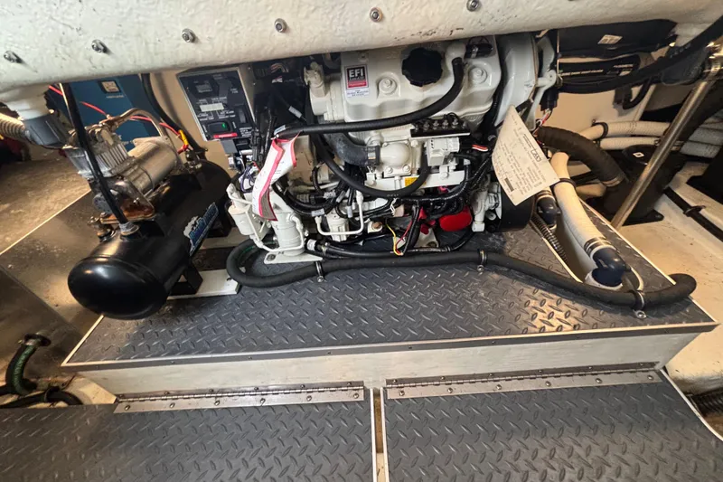 Slide: The Image of Engine compartment of a 2020 Formula 350 Crossover Bowrider with visible components and wiring. - 68