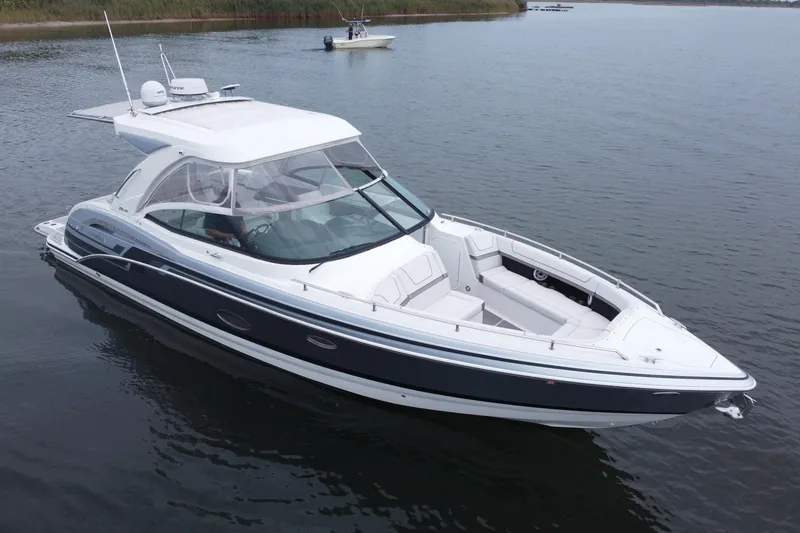 Slide: The Image of 2020 Formula 350 Crossover Bowrider on calm water, showcasing sleek design and spacious seating. - 7