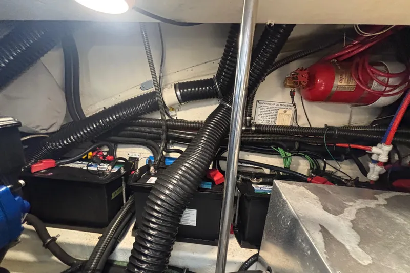 Slide: The Image of Engine compartment of 2020 Formula 350 Crossover Bowrider with batteries and fire extinguisher. - 70