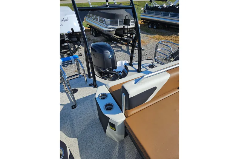 Slide: The Image of 2026 Trifecta 23 ULESS pontoon boat with Suzuki outboard motor and tan seating. - 17