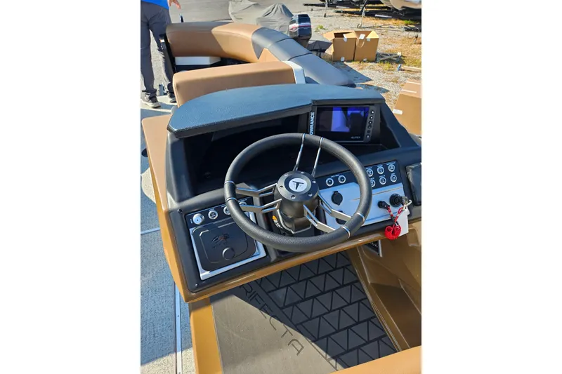Slide: The Image of 2026 Trifecta 23 ULESS boat dashboard with steering wheel and control panel. - 18