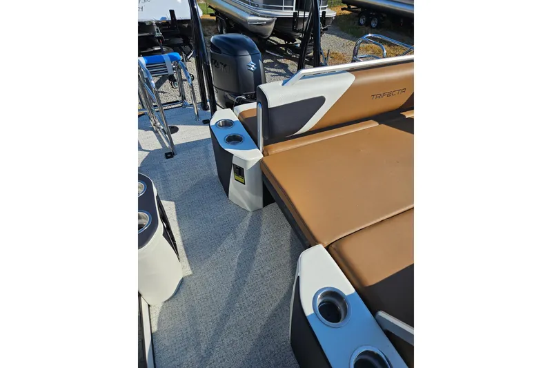 Slide: The Image of 2026 Trifecta 23 ULESS boat interior with brown seating and cup holders. - 20