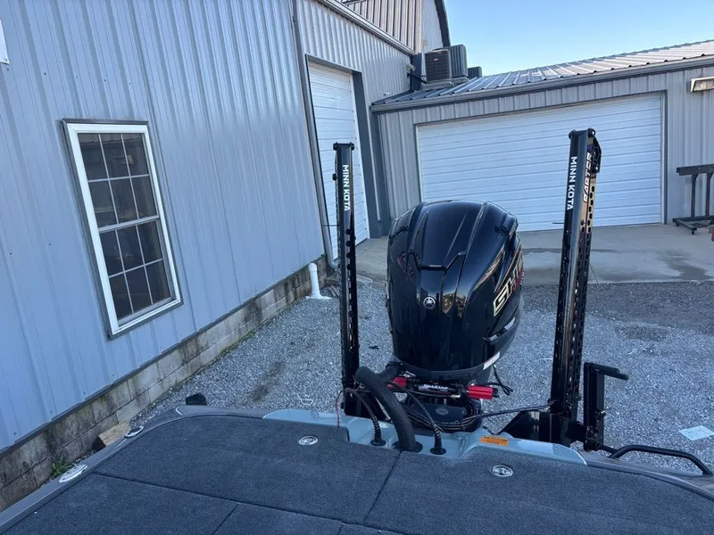 Slide: The Image of Skeeter ZXE20 2026 boat with Minn Kota motor in front of garage. - 8