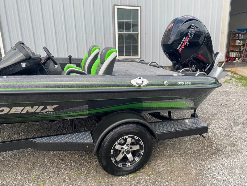 Slide: The Image of Phoenix Pro Series 818 boat, 2026 model, with green accents and outboard motor. - 11