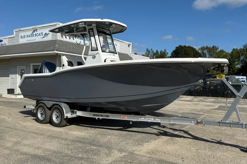 Slide: The Image of 2026 Tidewater 232 CC Adventure boat on trailer at Blue Water Boats dealership. - 12