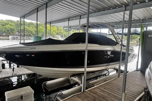 The Image of 2007 Sea Ray 270 SLX boat docked under covered marina. - 0