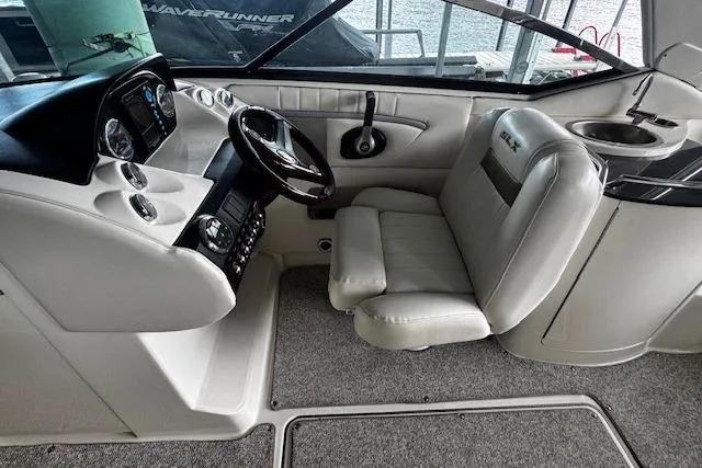 Slide: The Image of 2007 Sea Ray 270 SLX boat interior with steering wheel, dashboard, and seating. - 11