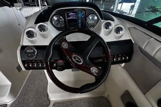 Slide: The Image of 2007 Sea Ray 270 SLX boat dashboard with steering wheel and instrument panel. - 12
