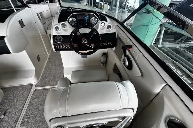 Slide: The Image of 2007 Sea Ray 270 SLX boat interior with steering wheel and dashboard controls. - 13