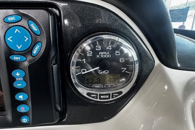 Slide: The Image of Dashboard of 2007 Sea Ray 270 SLX showing RPM gauge and control panel. - 15