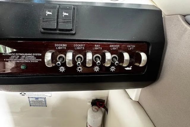 Slide: The Image of Control panel of a 2007 Sea Ray 270 SLX boat with various light switches. - 17