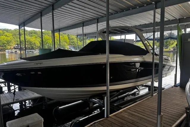 Slide: The Image of 2007 Sea Ray 270 SLX boat docked under a covered marina. - 2
