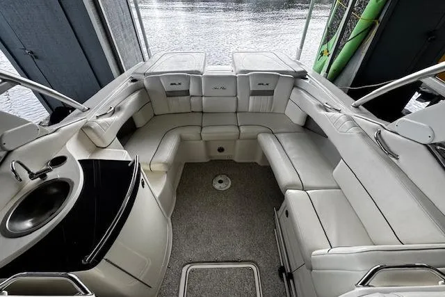 Slide: The Image of 2007 Sea Ray 270 SLX boat interior with white seating and a small sink. - 25