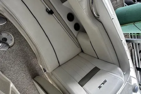 Slide: The Image of 2007 Sea Ray 270 SLX boat interior with white leather seating and carpeted flooring. - 30