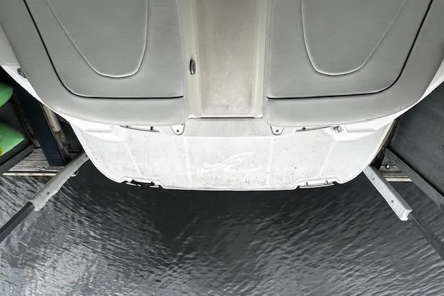 Slide: The Image of 2007 Sea Ray 270 SLX boat on lift above water, viewed from stern. - 38