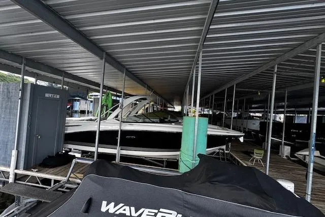 Slide: The Image of 2007 Sea Ray 270 SLX boat docked under covered marina. - 4