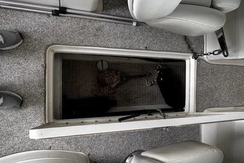 Slide: The Image of 2007 Sea Ray 270 SLX boat interior storage compartment with gray carpet and seating. - 42