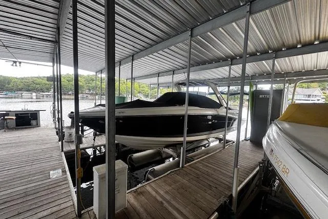 Slide: The Image of 2007 Sea Ray 270 SLX boat docked under a covered marina. - 6