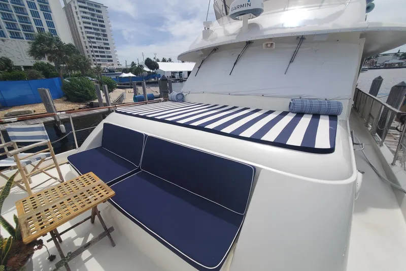 Slide: The Image of 1981 Hatteras 56 Motor Yacht with striped sunbed and blue seating on deck. - 3