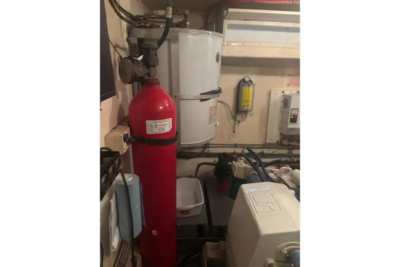 Slide: The Image of Engine room of 1981 Hatteras 56 Motor Yacht with fire extinguisher and equipment. - 33