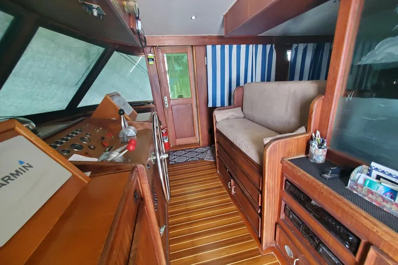 Slide: The Image of Interior of 1981 Hatteras 56 Motor Yacht with wood paneling and navigation equipment. - 9