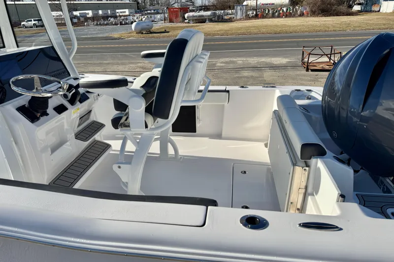 Slide: The Image of 2026 Tidewater 210 CC Adventure boat interior with seating and steering console. - 12