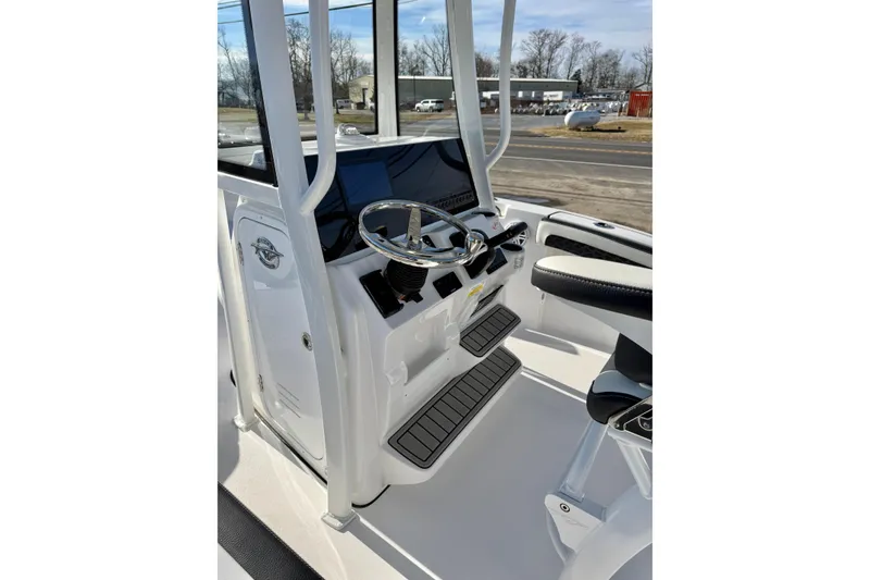 Slide: The Image of 2026 Tidewater 210 CC Adventure boat console with steering wheel and seating. - 14