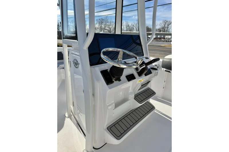 Slide: The Image of 2026 Tidewater 210 CC Adventure boat console with steering wheel and controls. - 15