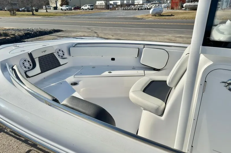 Slide: The Image of 2026 Tidewater 210 CC Adventure boat interior with seating and speakers. - 17