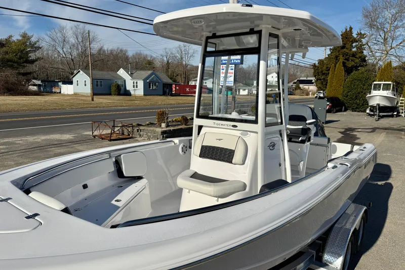 Slide: The Image of 2026 Tidewater 210 CC Adventure boat on trailer, parked outdoors on a sunny day. - 18