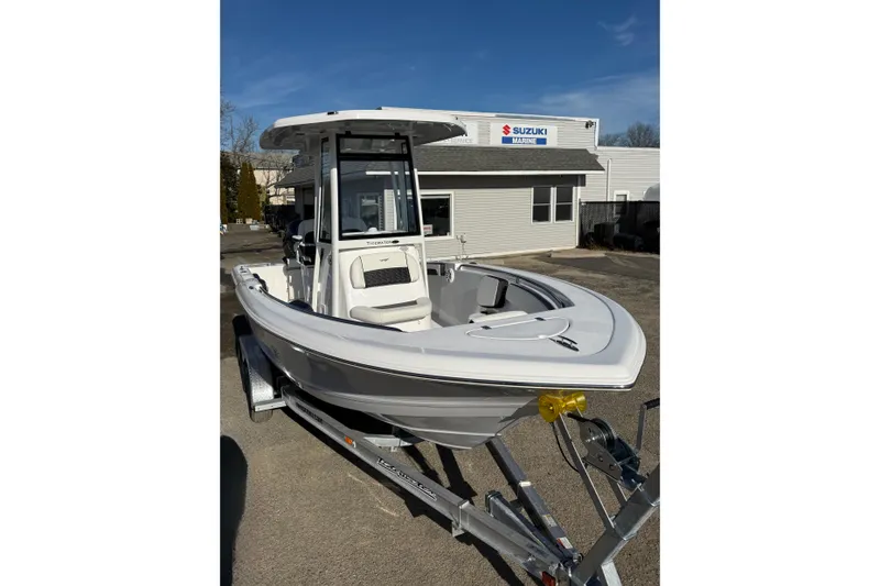 Slide: The Image of 2026 Tidewater 210 CC Adventure boat on trailer at Suzuki Marine dealership. - 19