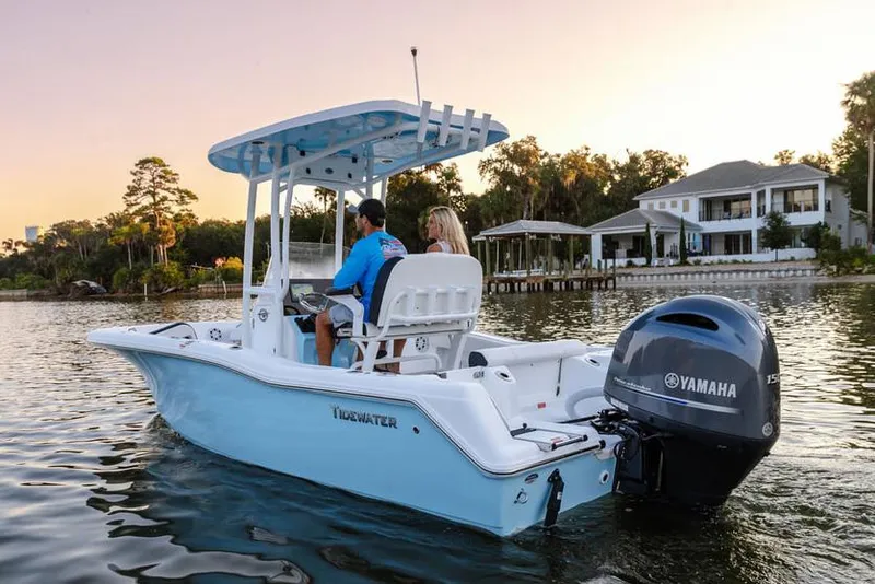 Slide: The Image of 2026 Tidewater 210 CC Adventure boat on trailer at Suzuki Marine dealership. - 2