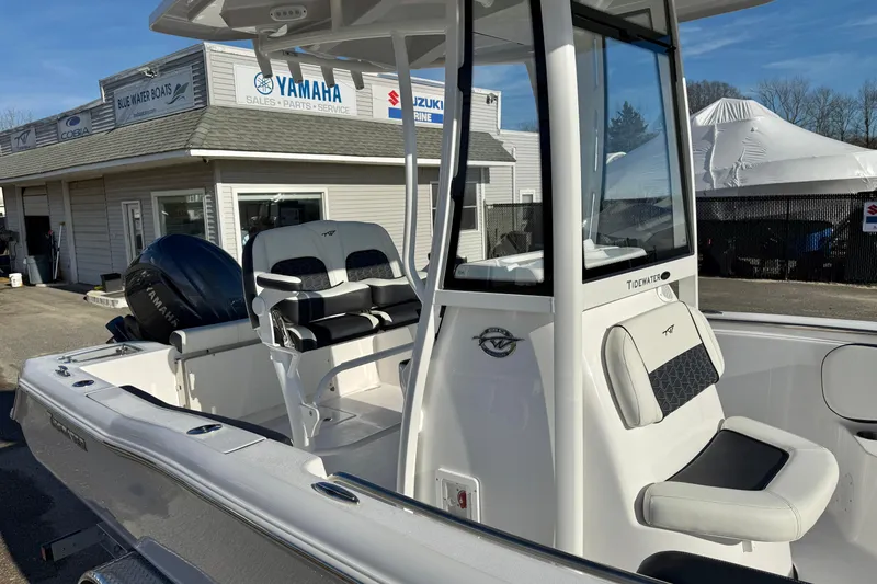 Slide: The Image of 2026 Tidewater 210 CC Adventure boat at dealership, featuring Yamaha engine and modern seating. - 21