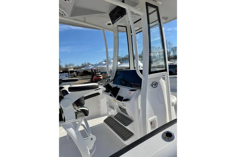 Slide: The Image of 2026 Tidewater 210 CC Adventure boat interior with modern helm and seating. - 22