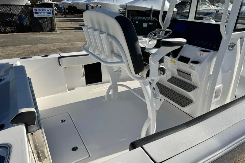 Slide: The Image of 2026 Tidewater 210 CC Adventure boat interior with helm and seating area. - 24