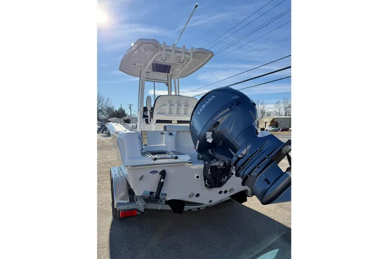 Slide: The Image of 2026 Tidewater 210 CC Adventure boat with Yamaha outboard motor, parked outdoors. - 26