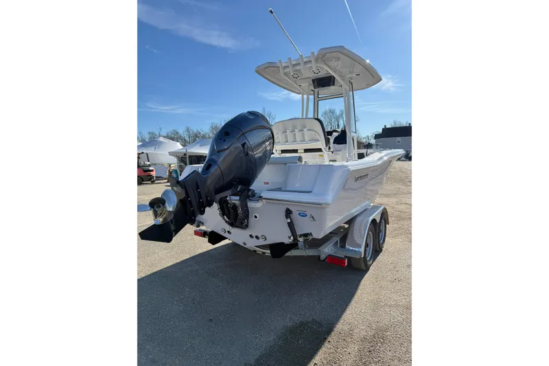 Slide: The Image of 2026 Tidewater 210 CC Adventure boat on trailer, featuring powerful outboard motor. - 28