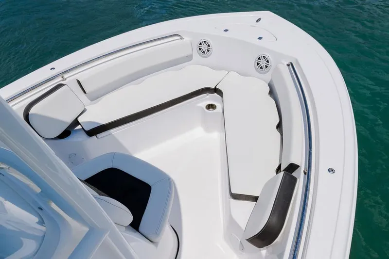 Slide: The Image of 2026 Tidewater 210 CC Adventure boat on trailer at dealership, clear sky background. - 4